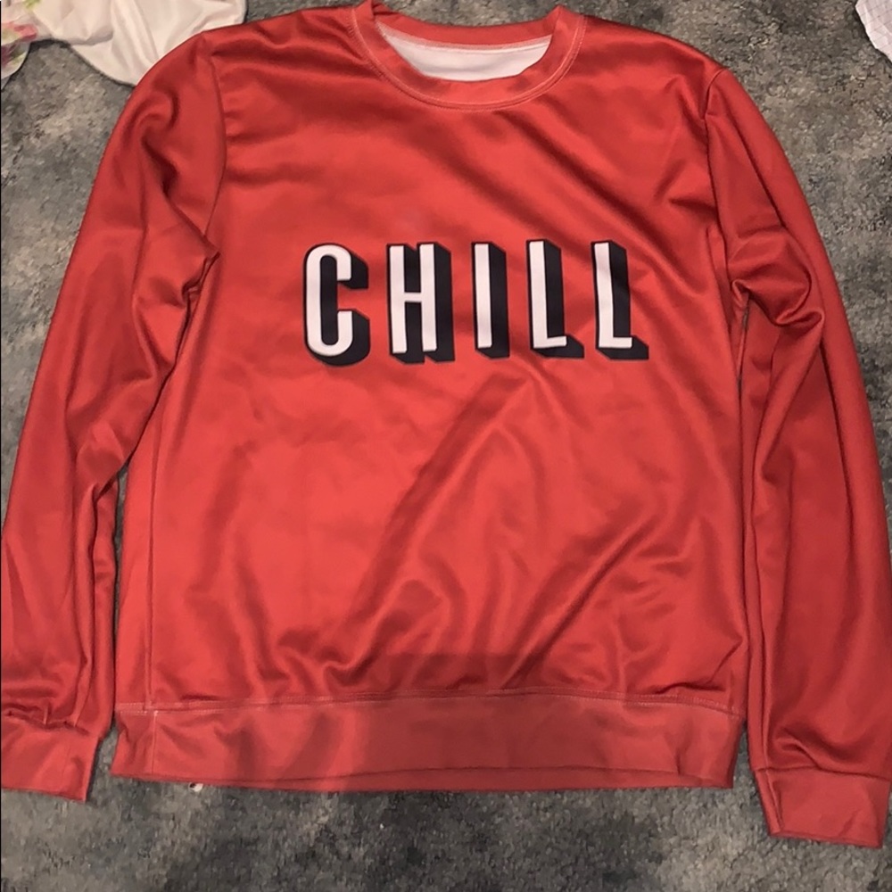 Red sweatshirt that says “chill”.